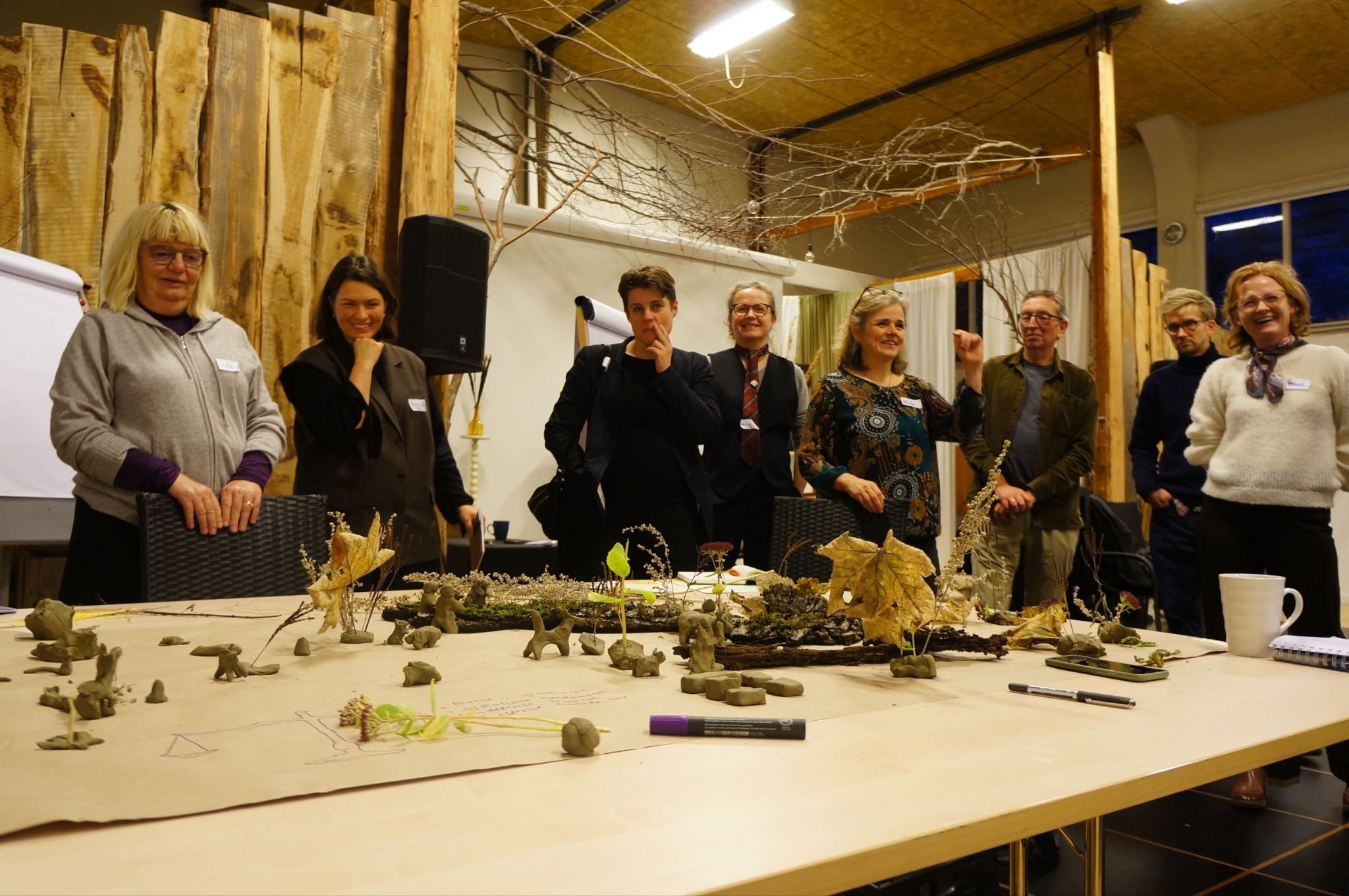 People gathered around table looking at objects